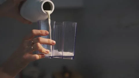 Milk is poured into a transparent container Stock Footage 305224069
