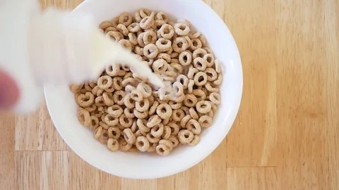 Milk Pouring Into Breakfast Cereal Stock Footage 83517997