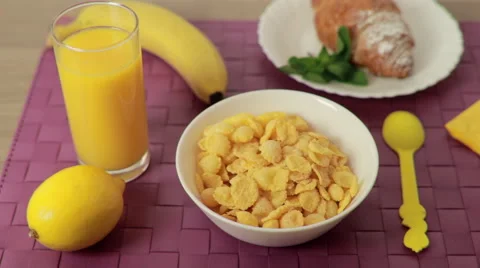 Milk pouring into cereal bowl at breakfast Stock Footage 59603853