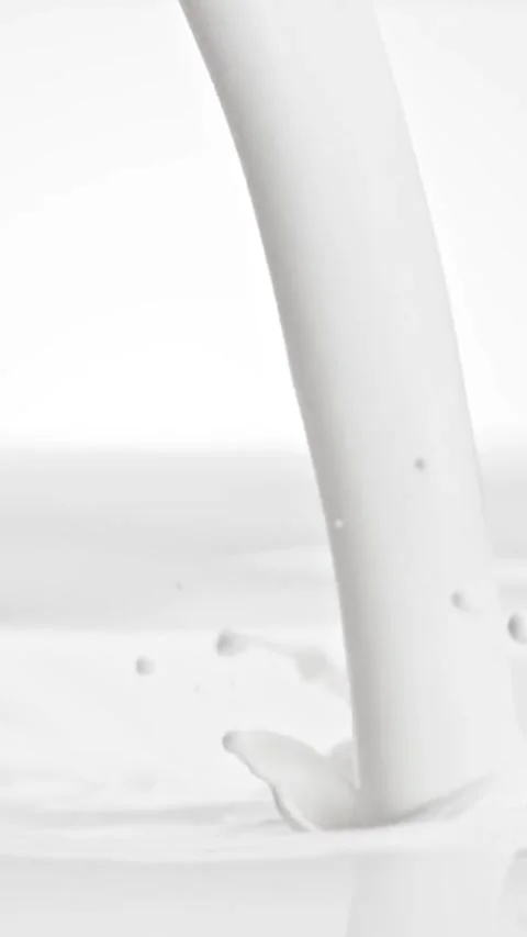 Milk pouring into liquid surface splash. Video stock 335706514