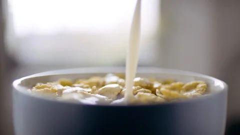 Milk pouring over cereal Stock Footage 128511920