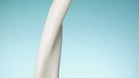 Milk pouring over flat background Stock Footage 148953455