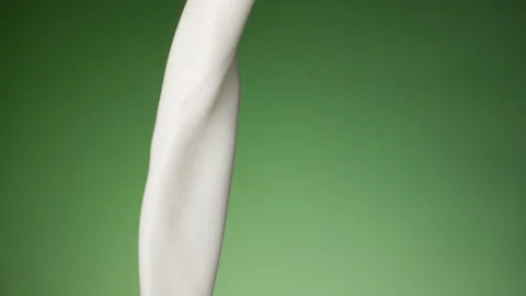Milk pouring over flat background Stock Footage 148953622