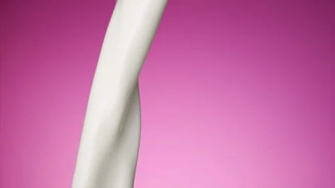 Milk pouring over flat background Stock Footage 148953623