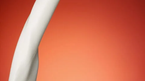 Milk pouring over flat background Stock Footage 148953770