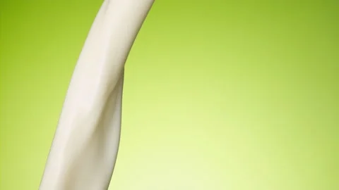 Milk pouring over flat background Stock Footage 148953923