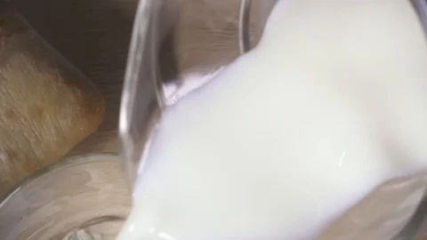 Milk pours from the decanter top view close-up Stock Footage 87989569