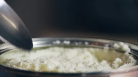 Milk Powder Serving with Spoon Stock Footage 158825608