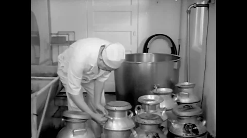 Milk is pumped from the receiver vat to the pasteurization vat. Stock Footage 74704703