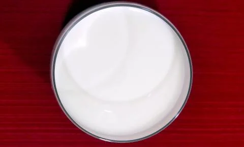Milk on red Stock Photos