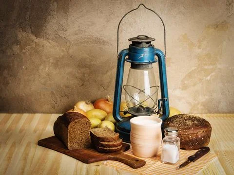 Milk, rye bread, a cutting board, salt and salt salt, onions, potatoes Stock Photos