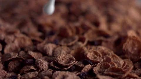Milk spilling over the cornflakes in slow motion Stock Footage 81230347