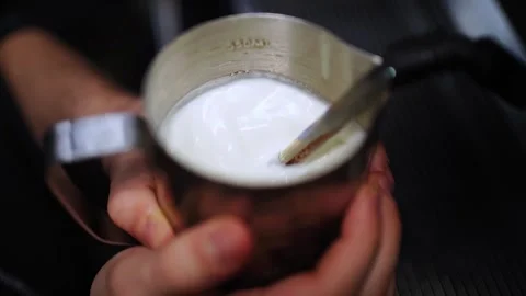 Milk steaming when making coffee Stock Footage 303835199