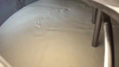 Milk is stirred in a pasteurization boiler Stock Footage 85601335