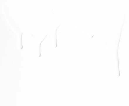 Milk streams on a white background . Stock Photos