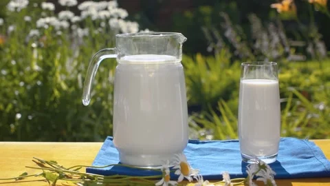 Milk on the table in the garden Stock Footage 137623229