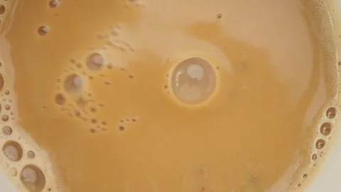 Milk tea surface macro shot with air bubbles forming after pouring drink in.. Stock Footage 332783135