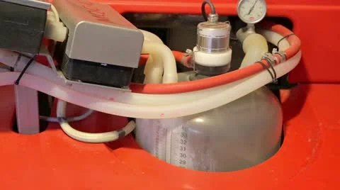 Milking machine with milk coming in Stock Footage 22215769