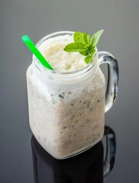 Milkshake mint in jar with a straw Stock Photos
