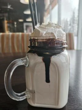 Milkshake mug on a brown table in a cafe Foto stock