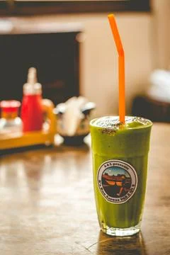Milkshake of spinach, banana, mango, soymilk, soy protein, ice, chia servedn  Stock Photos
