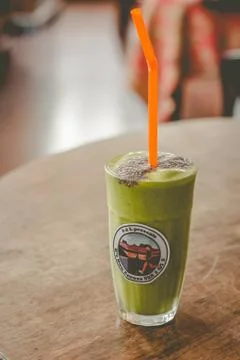 Milkshake of spinach, banana, mango, soymilk, soy protein, ice, chia servedn  Stock Photos