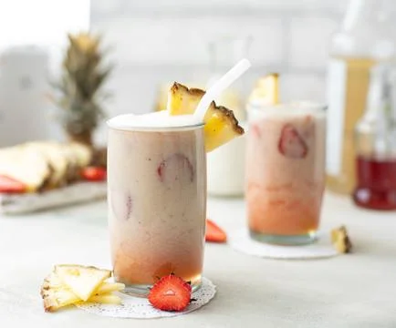Milkshake with strawberries and pineapple Stock Photos