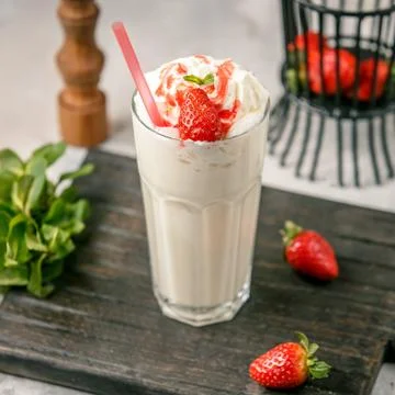Milkshake with strawberry on the table Stock Photos