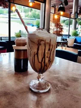Milkshake on a table in a cafeteria Stock Photos