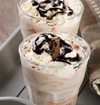 Milkshake with whipped cream. Selective focus Stock Photos
