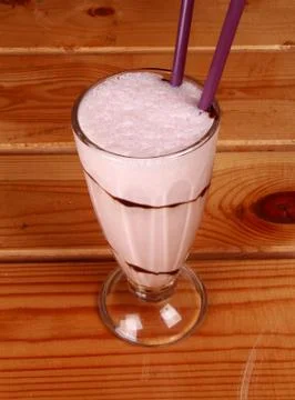 Milkshake on wooden background Stock Photos