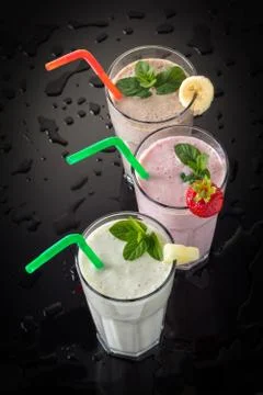 Milkshakes on a black background Stock Photos