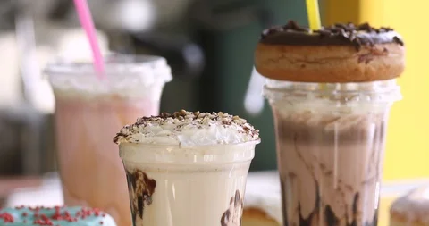 Milkshakes with donuts for takeaway in a cafe Stock Footage 90461814
