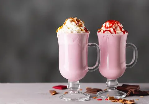 Milkshakes with toppings on gray Stock Photos