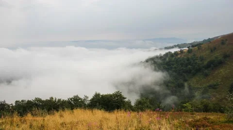 Milky clouds grow in the mountains. Timelapse 库存影片 54987786