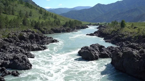 Milky rapid mountains river flow through volcanic rocks Stock Footage 113139718