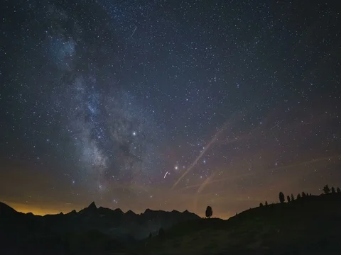 Milky Way and the starry sky beyond snowcapped mountain Stock Footage 77713580