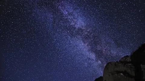 Milky Way Galaxy Rotating over Rocks Night Time Lapse Stock Footage 130970907
