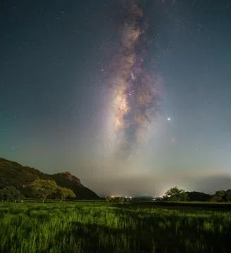Milky Way over a grass field Stock Photos