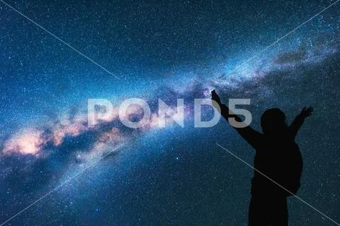 Milky Way. Silhouette of a happy woman. Space Stock Photos