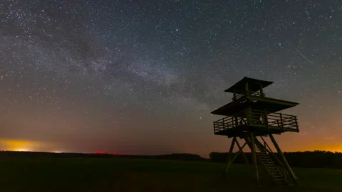 Milky Way Time-Lapse Over Open Landscape with Observation Tower Stock Footage 327458760