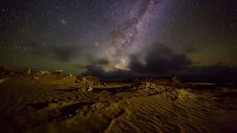Milkyway Rising over remote sand dune landscape Stock Footage