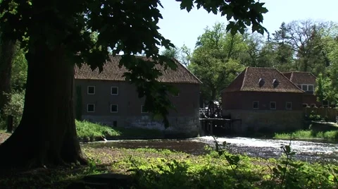 Mill pond + ancient water mill powered by a breastshot water wheel Stock Footage 57392380