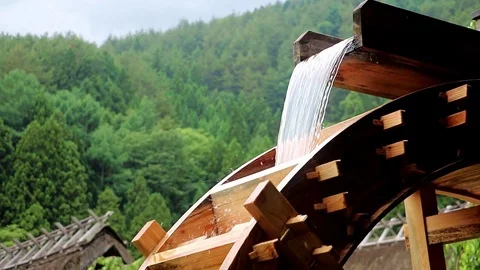 The mill wheel rotates under a stream of water. Stock Footage 80968129