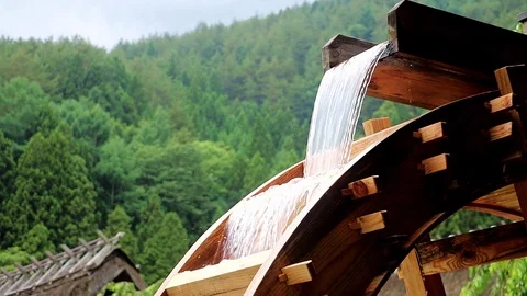 The mill wheel rotates under a stream of water. Stock Footage