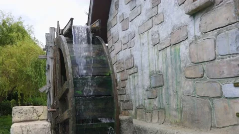 Mill wheel rotates under water, open-air museum in the village Stock Footage 231380253