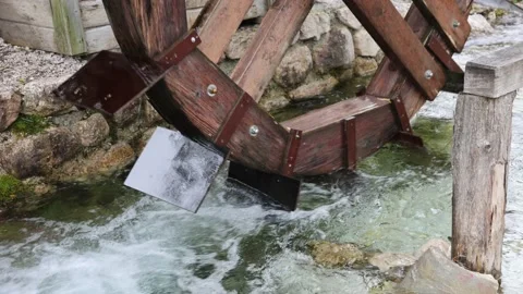 A mill wheel turns in a stream Stock Footage 169038177
