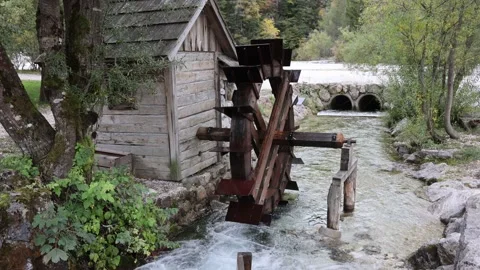 A mill wheel turns in a stream in the Julian Alps in Triglav National Park, Slov Stock Footage 168902365