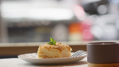 Mille feuille cake with mint leaf and coffee cup Stock Footage 300586888