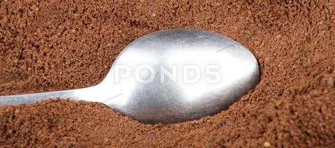 Milled coffee and teaspoon Stock Photos